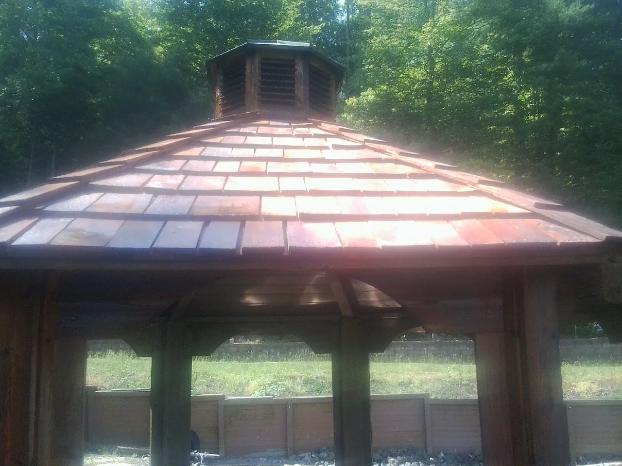 New cedar shake roof and cupola on a lakeside gazebo in Unityville