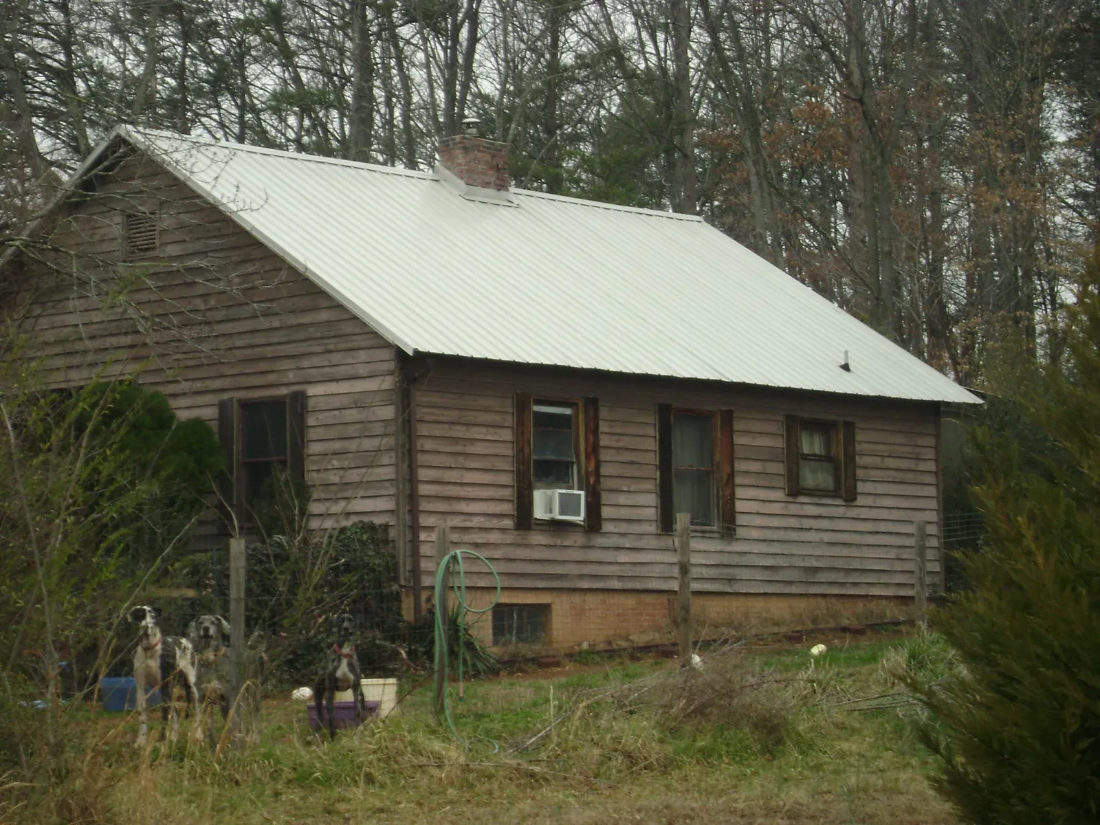 White metal roof on an old wood sided farmhouse, from a Metal Roof Installation job in Unityville